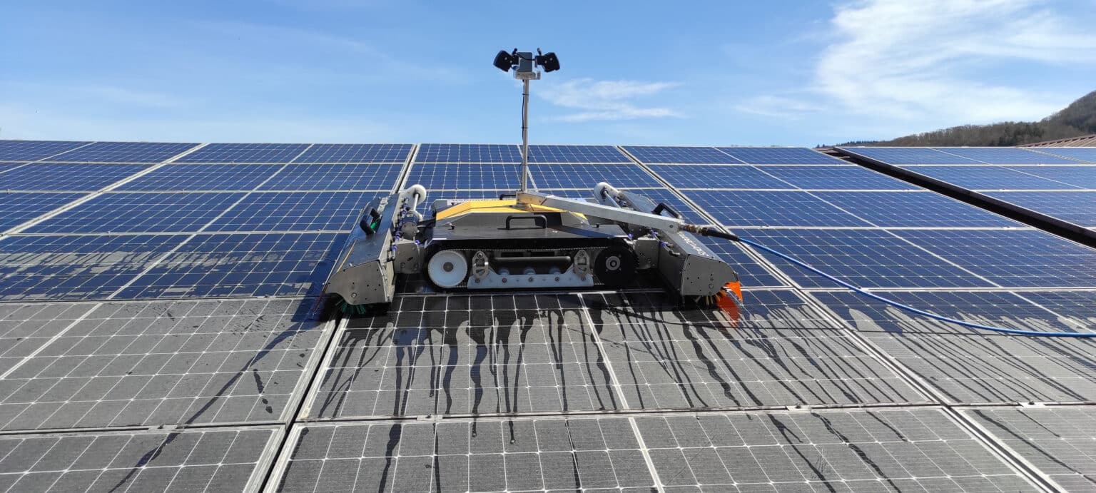 Photovoltaic cleaning with a robot in which brushes are inserted